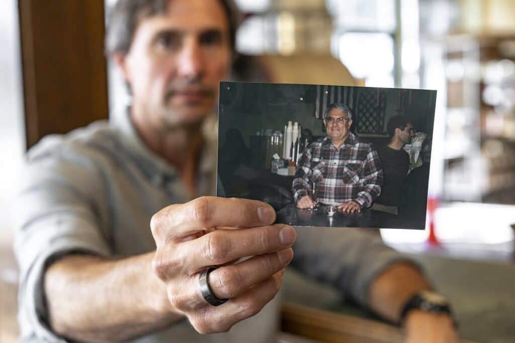 Ben Sange with a photo of his father, Leon.