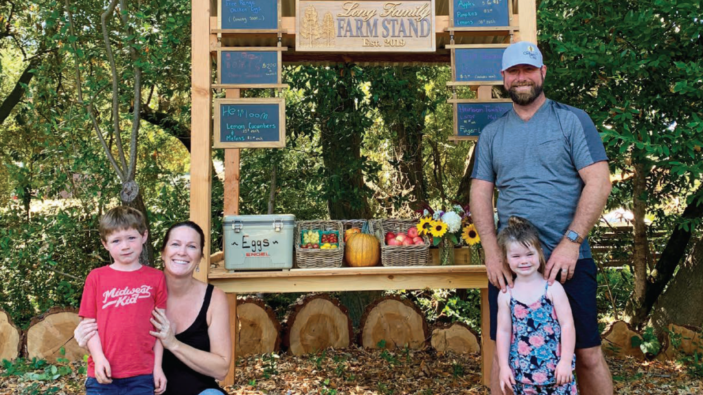 family in front of farmstand