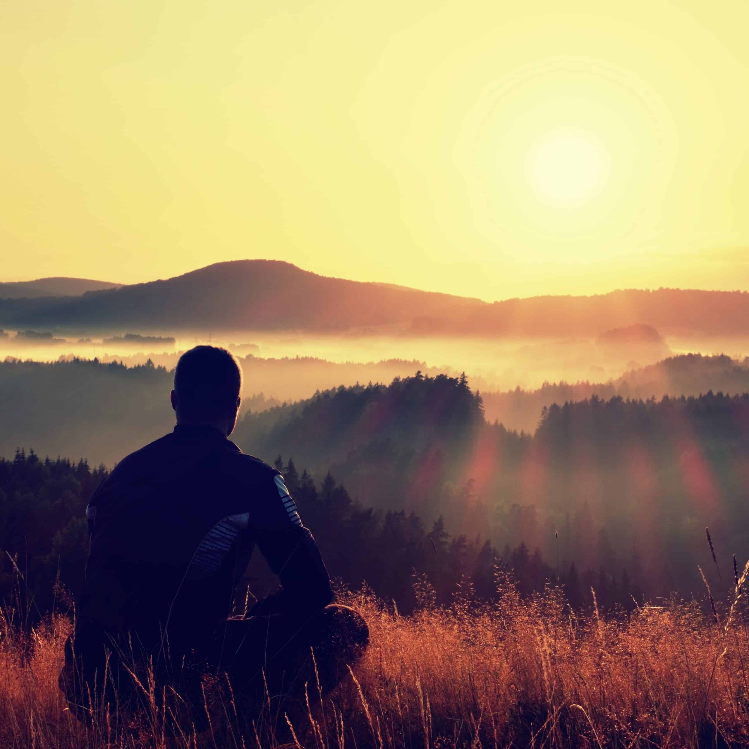 Hiker,In,Squatting,Position,In,High,Grass,Meadow,Enjoy,The