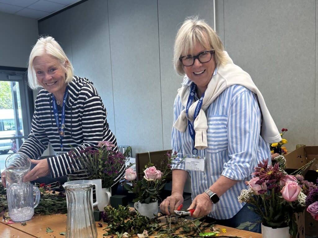 Sharon Campbell and Katie Anderson arranging flowers