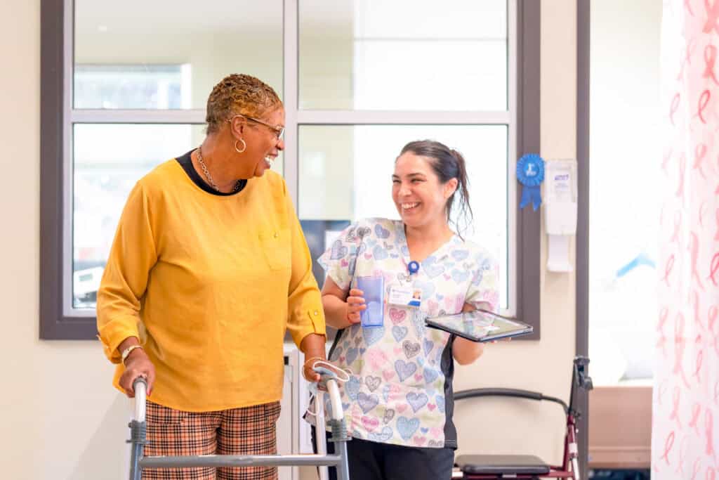 Day Program Participant and staff member smiling at each other