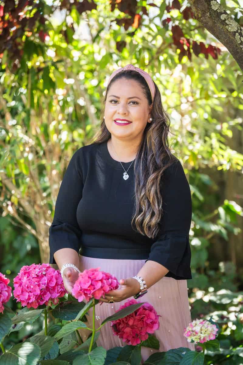 Portrait of Yessenia with red flowers